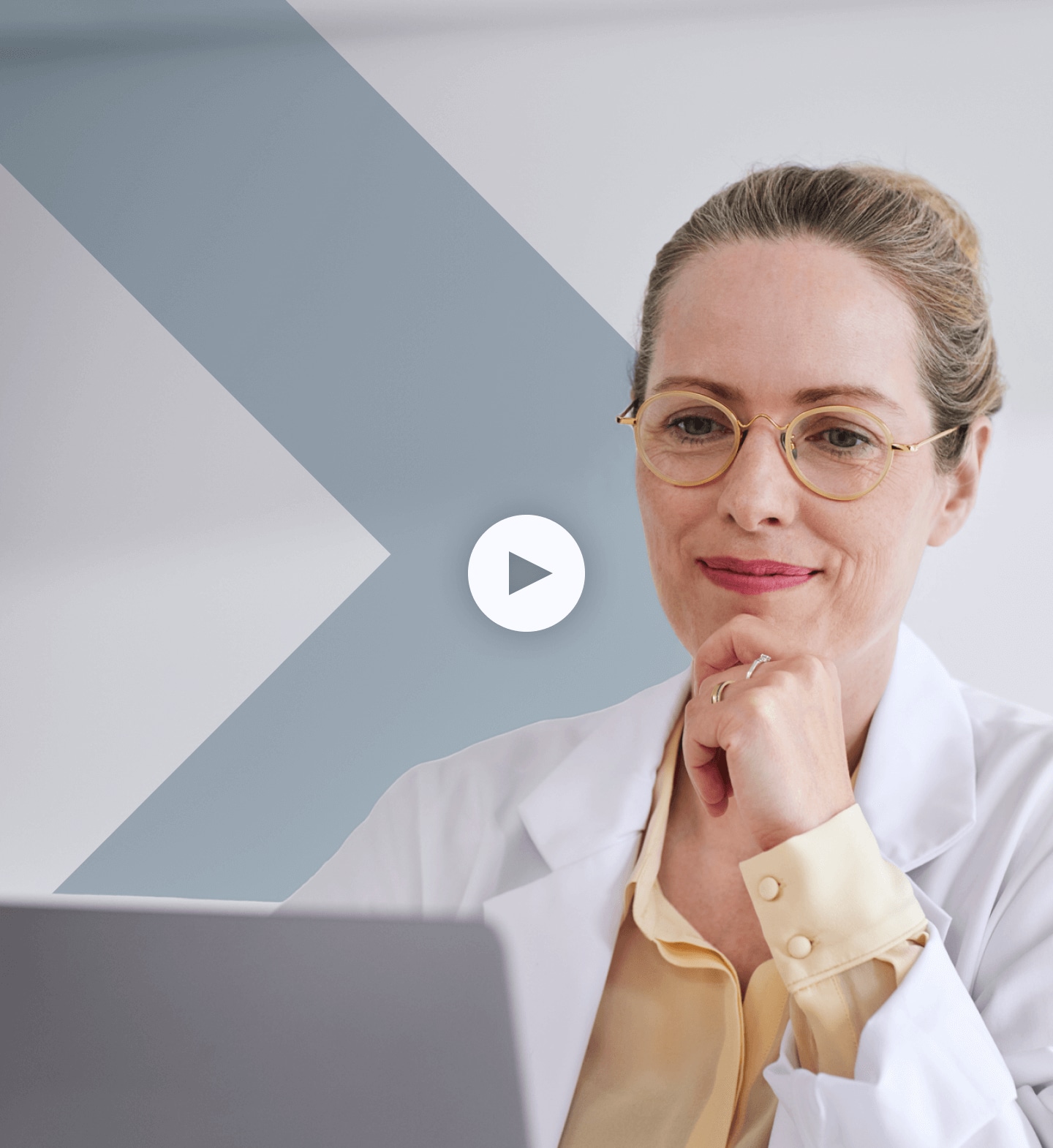 Radiologist smiling looking at laptop