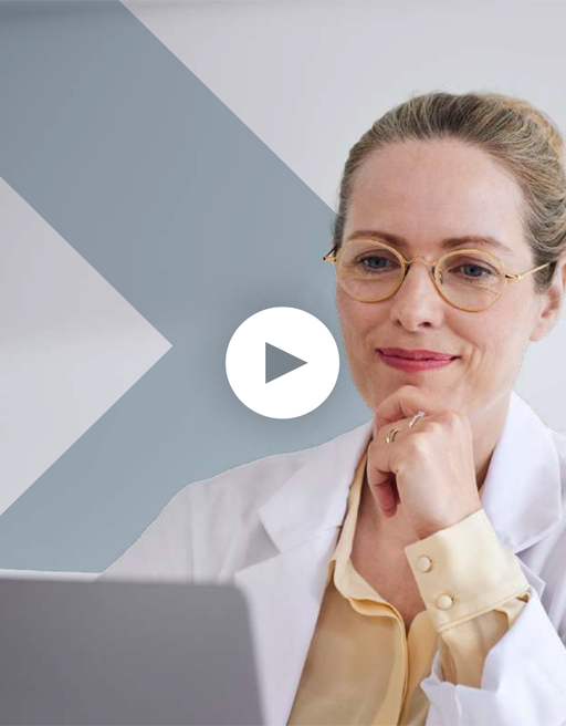 Radiologist smiling looking at laptop